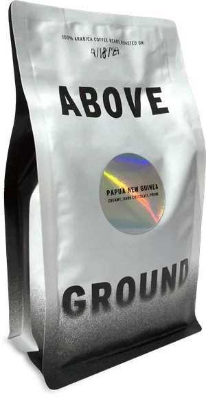 An Above Ground bag of Papua New Guinea, whole bean, with its roast date written on the front